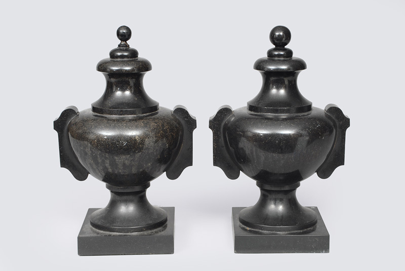 A pair of black marble vases