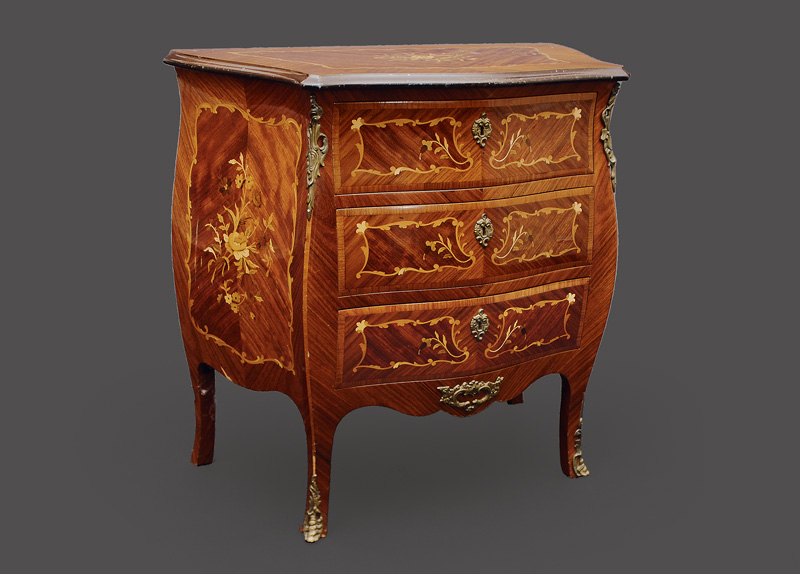 A petite chest of drawers in the style of baroque