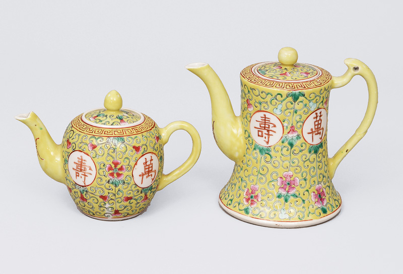 Two small yellow grounded pots with floral decoration