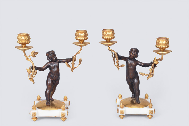 A pair candlesticks with puttos