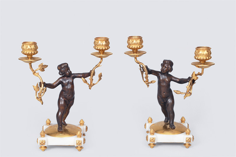 A pair candlesticks with puttos