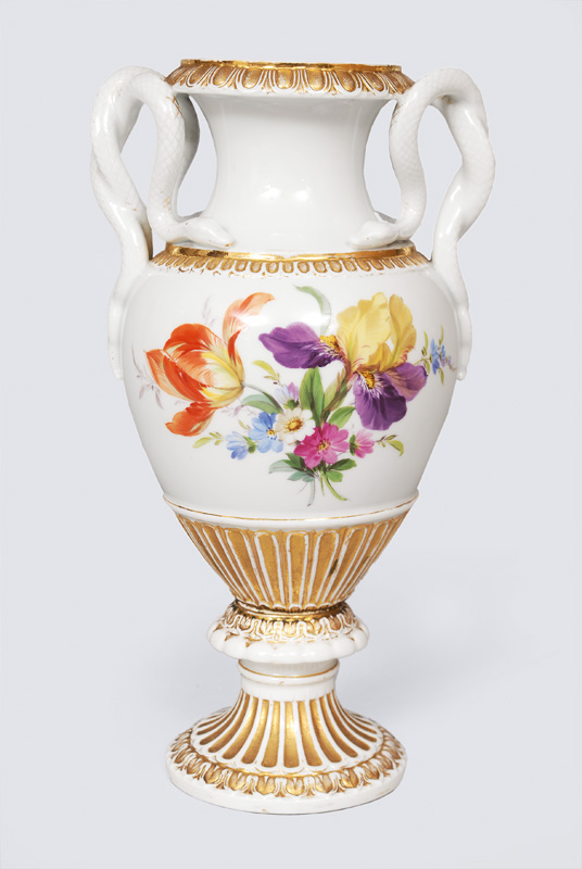 A snake handle vase with flower decoration