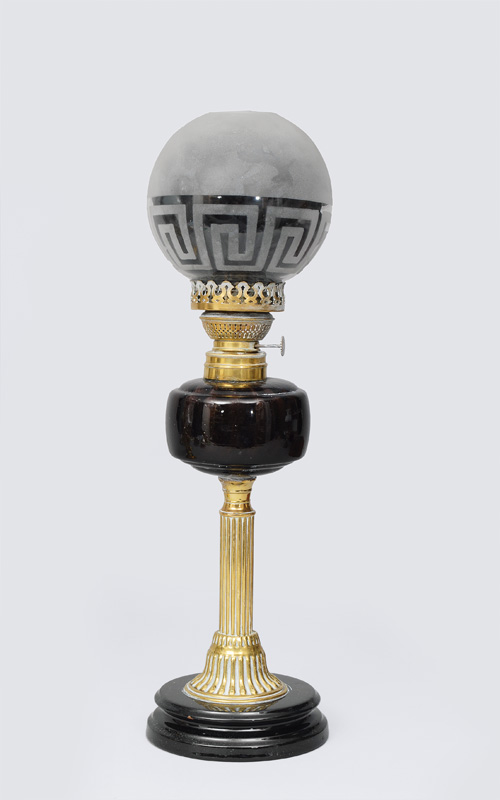 A petrol lamp with a meander frieze decorated lampshade