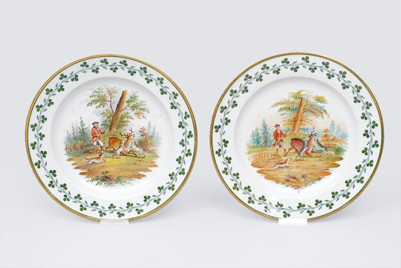 A pair of plates with a hunting scene
