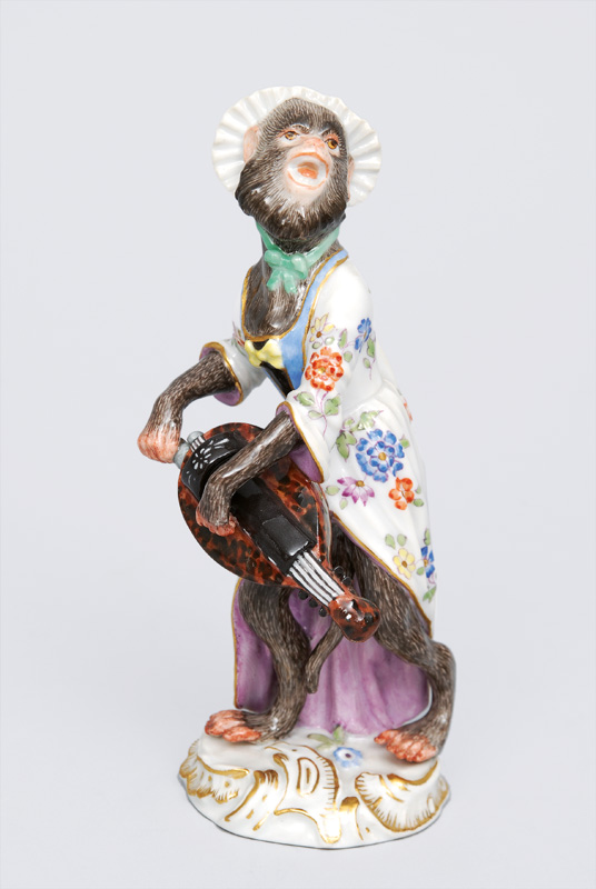 A figurine "female hurdy-gurdy player" of serial "music playing monkeys"