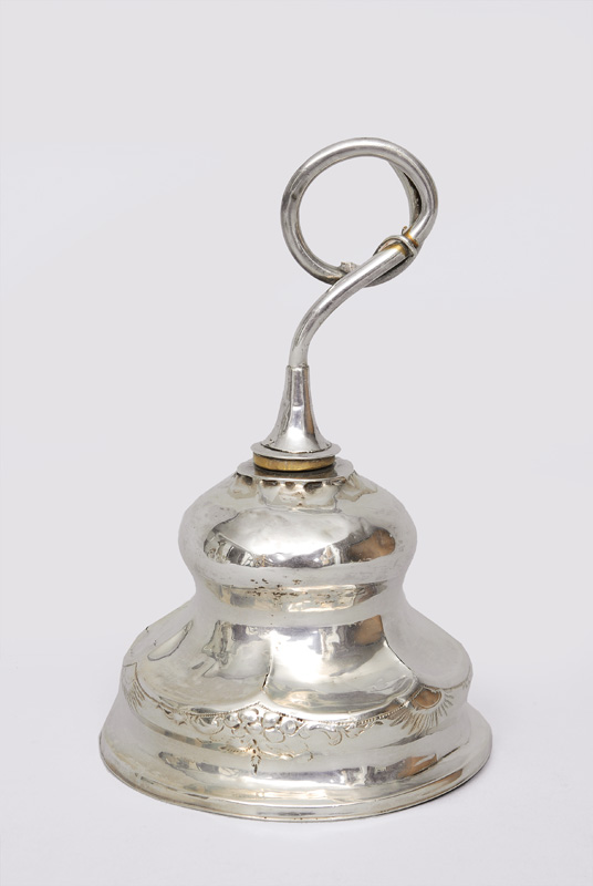 An elegant table bell with floral decoration