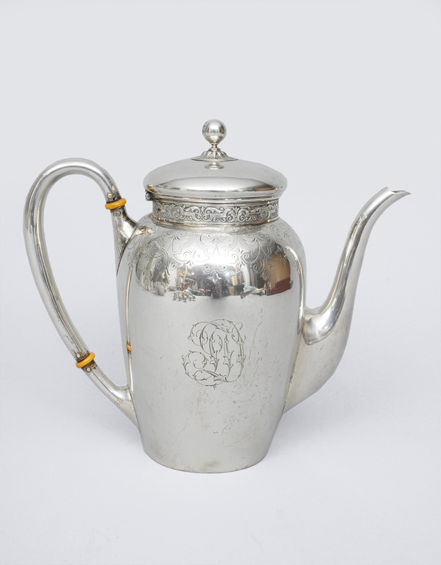 A coffee pot with engravings