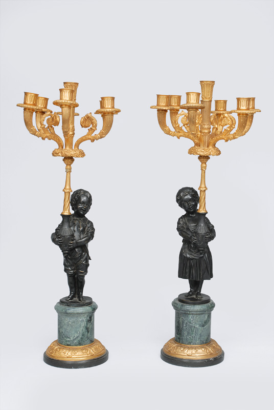A pair of large bronze candle holders with two figures