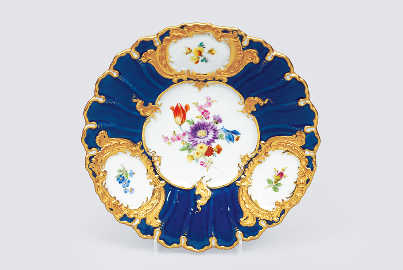 A cobalt blue grounded plate with flower decoration