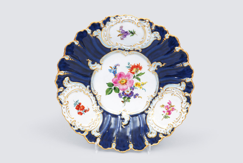 A cobalt blue grounded plate with flower decoration