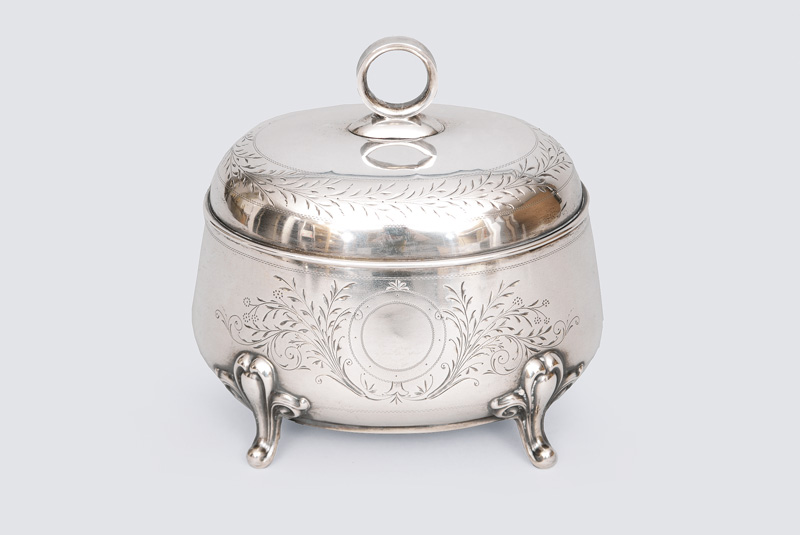 A sugar bowl with fine engraved leaf decoration