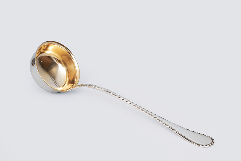 A soup ladle with pearl-shaped frieze