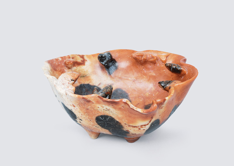 A lotus-shaped bowl with applied fish and shells