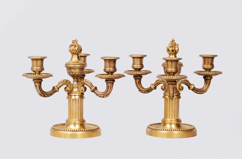 A pair of candlesticks with 3 lights