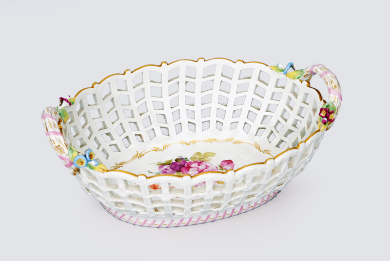 An oval open worked bowl with branch-shaped handles and blossoms