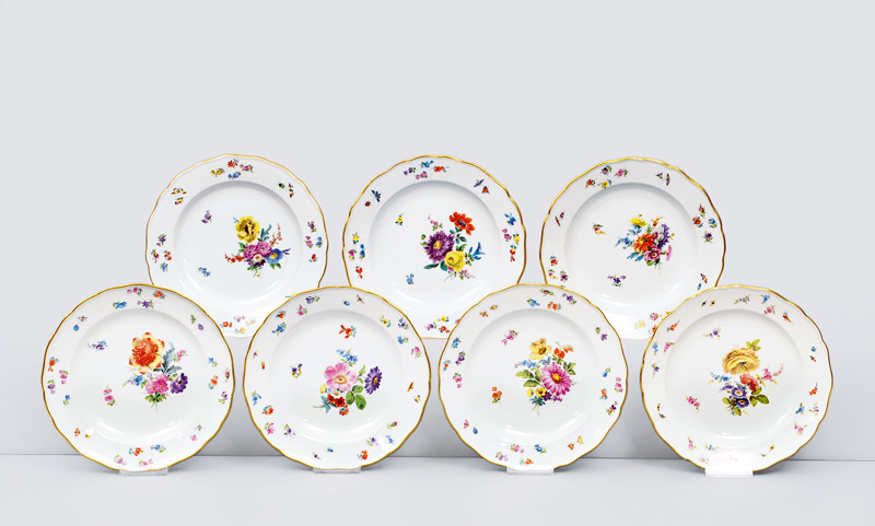A set of 7 plates with flower painting, insects and gold rim