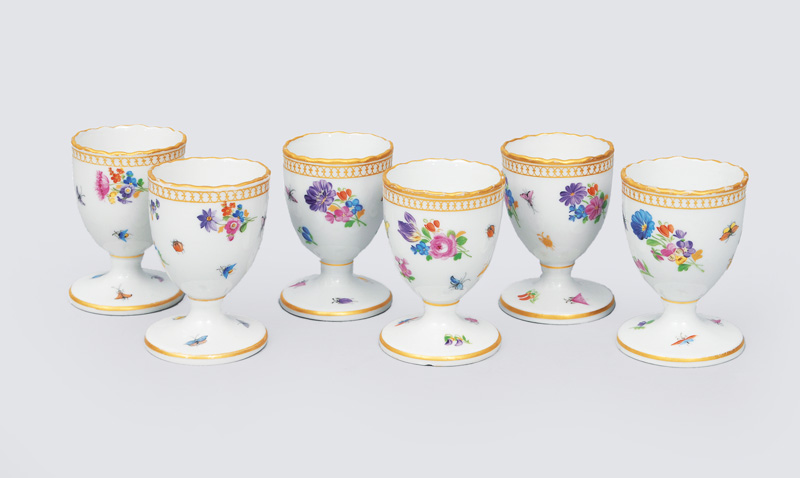A set of 6 egg cups with flower paintings, insects and gilded rim