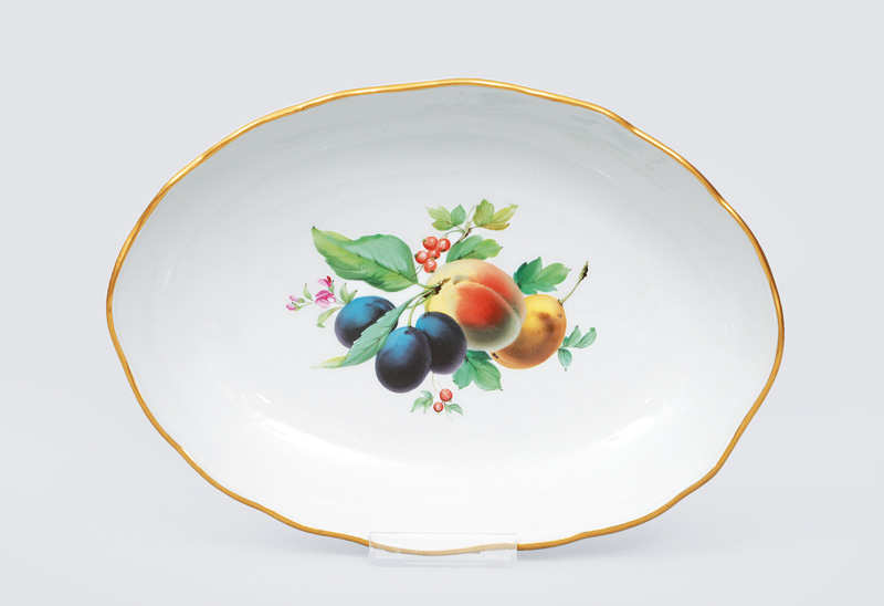 An oval bowl with fruit painting and gilded rim