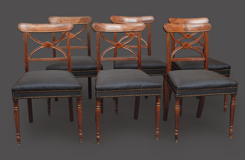 A large Victorian table with 6 chairs
