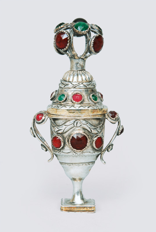 An fragrance jar in the shape of a vase with rich ornaments