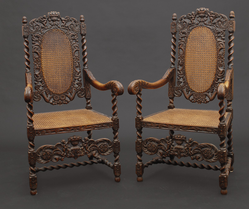 A pair of richly carved armchairs