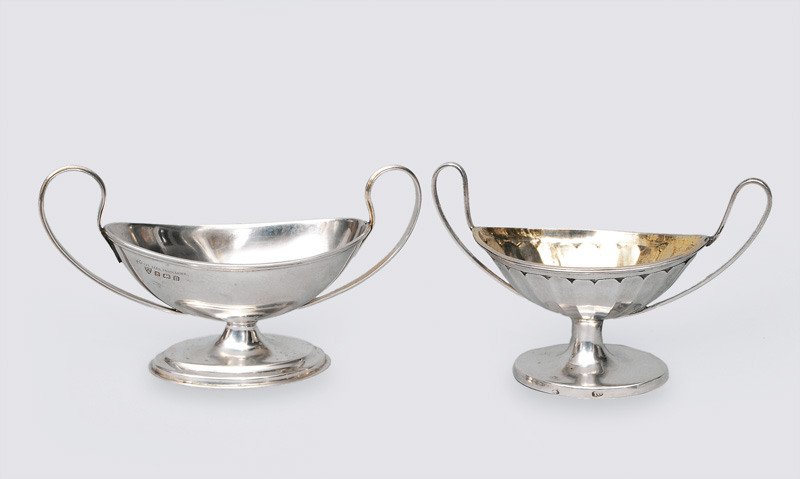 A pair of classical, small bowls with handles