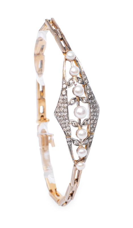 A petite pearl diamond bracelet in the style of Art-Nouveau