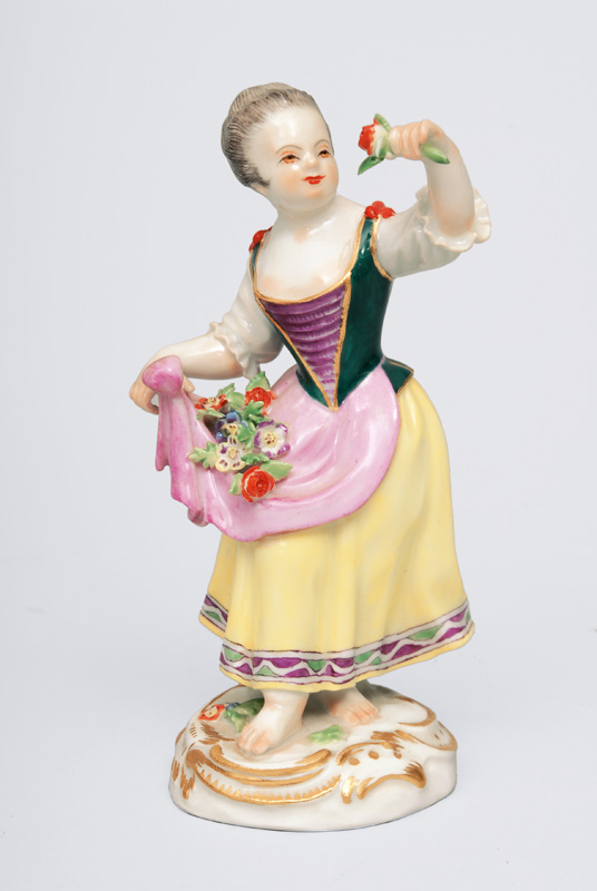 A figurine Gardener"s child with flower pinafore"