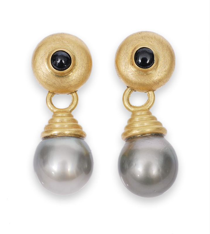 A pair of Tahiti pearl earrings with small sapphire cabochons
