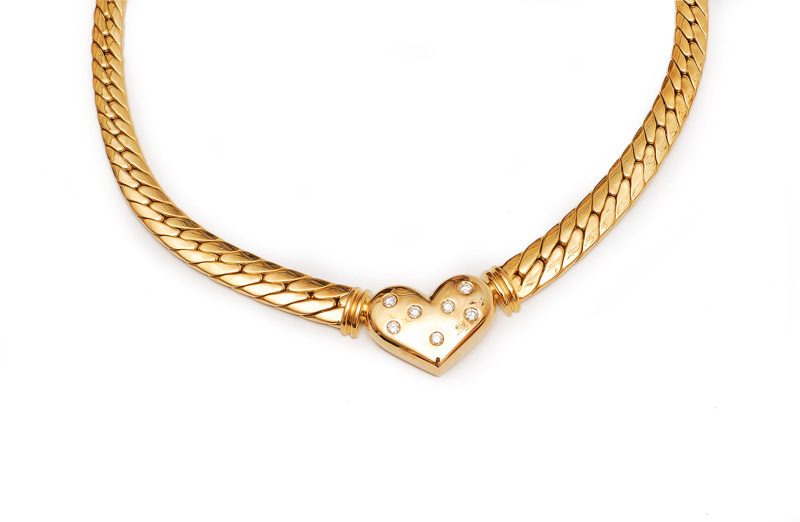 A golden necklace with diamond heart