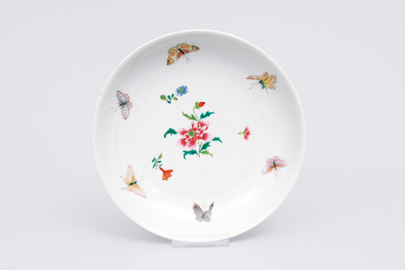 A flat famille rose bowl with butterflies