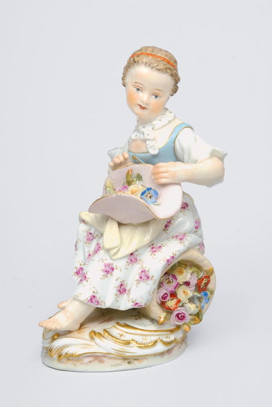 A figurine. "Gardener"s child with flower hat"