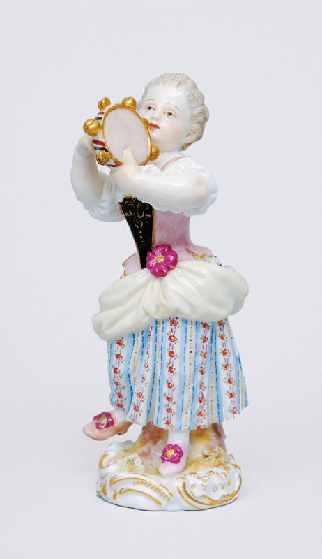 A figurine "Gardener"s child playing the tambourine"