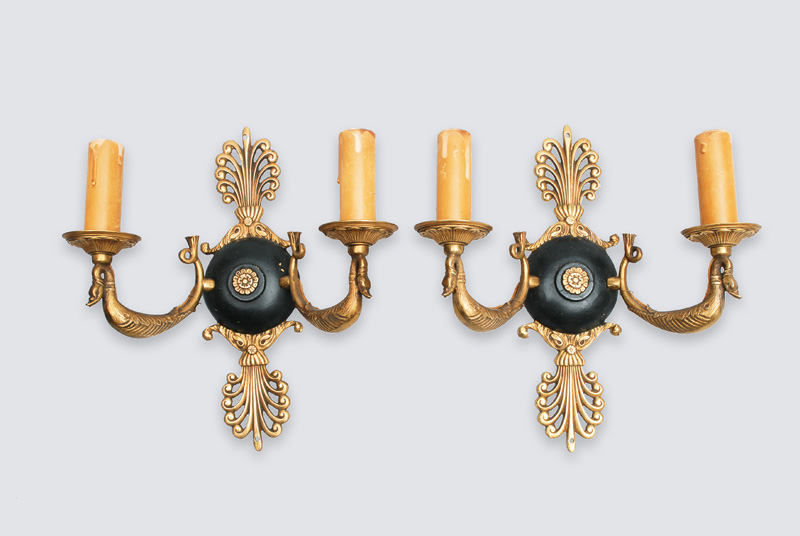 A pair of wall lights in the style of Empire