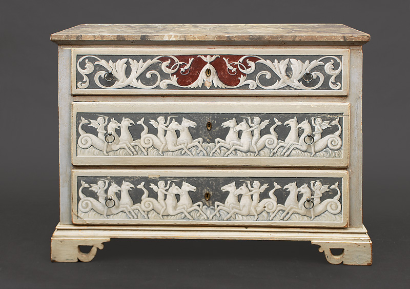 A coloured Louis-Seize chest of drawers with decoration of hippocampus