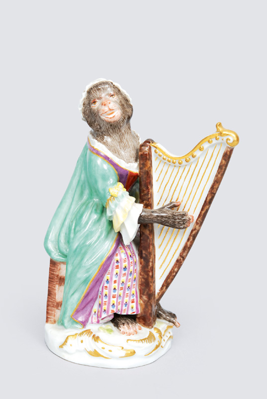 A figurine "female harp player" of serial "music playing monkeys"