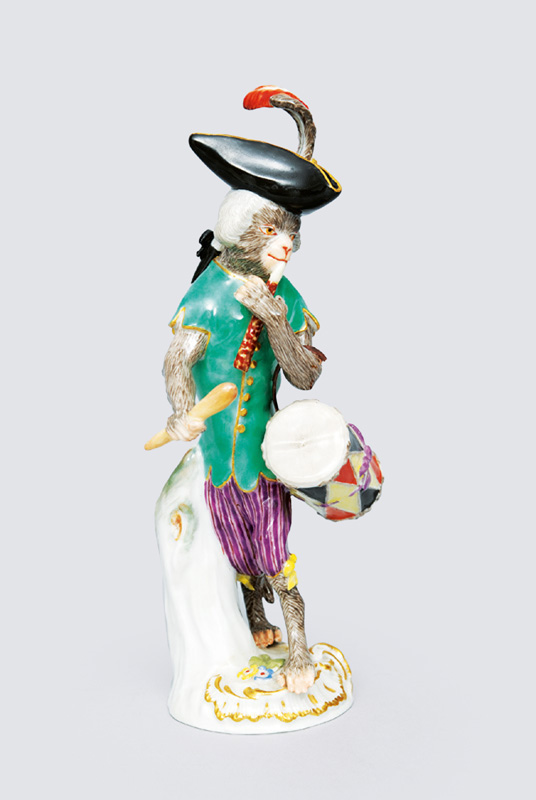 A figurine "drummer" of serial "music playing monkeys"