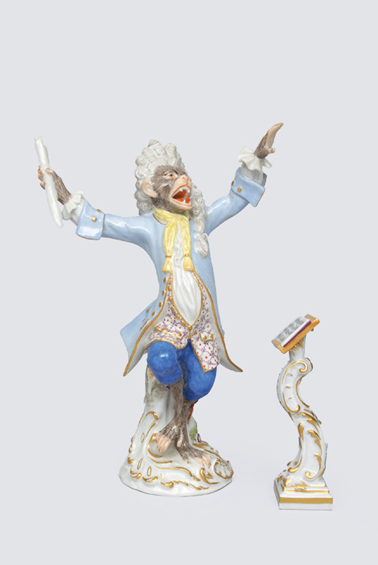 A figurine "chief conductor" of serial "music playing monkeys"