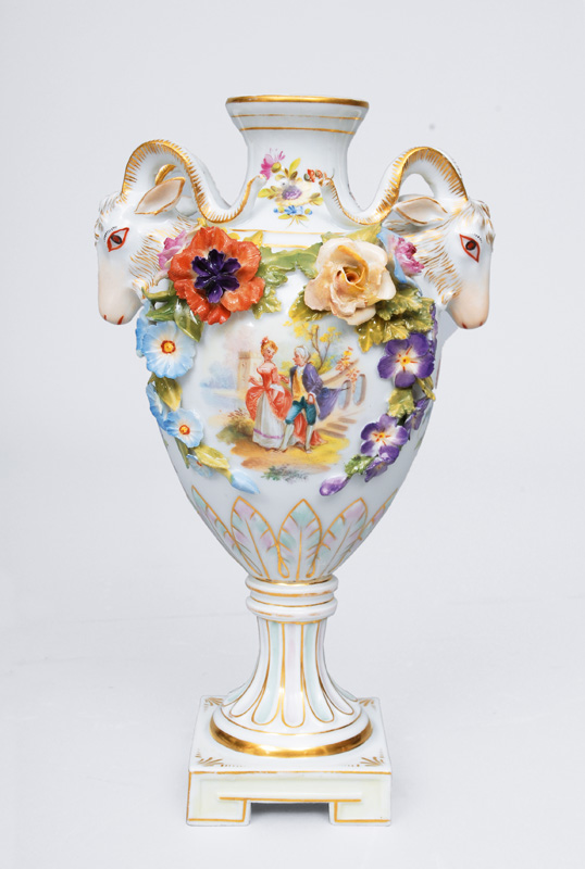 A small pompous vase with galant scene and ram heads