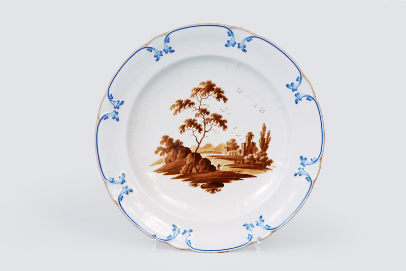 A big plate with river landscape in sepia painting A big plate with river landscape in sepia painting