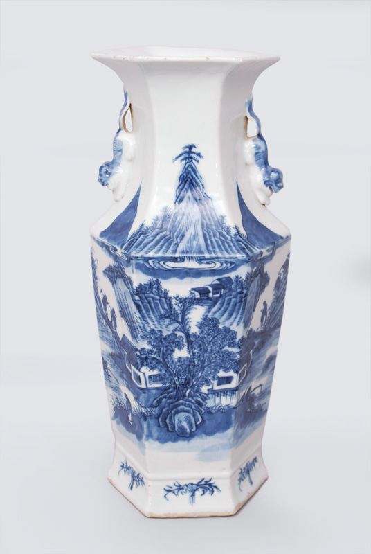 A hexagonal-shaped vase with river landscape