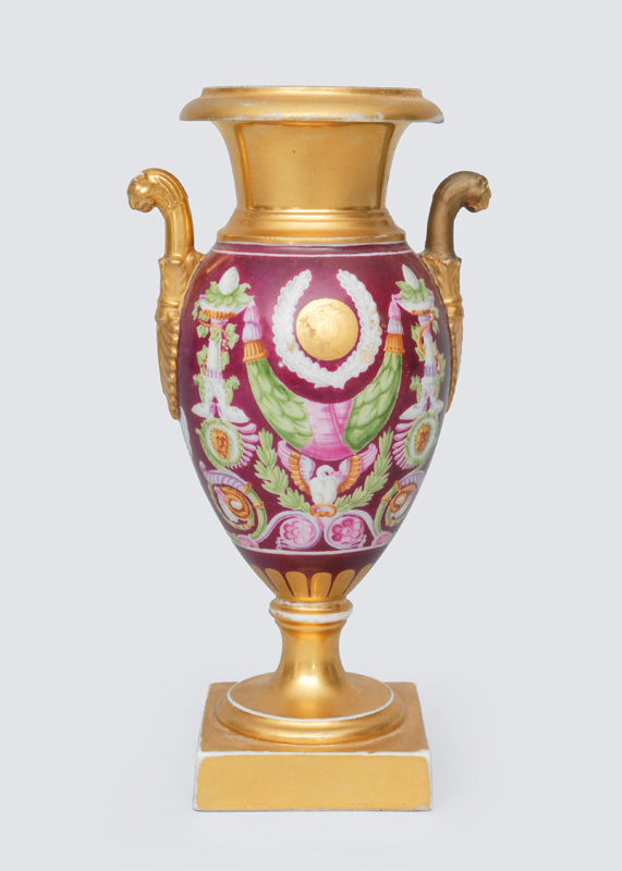 A small vase with lion"s head handles