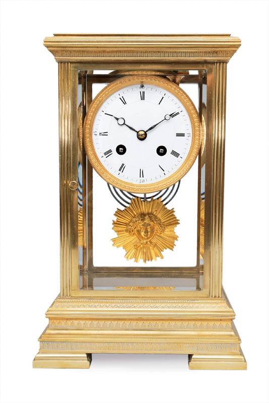 A mantle clock with glass cupola