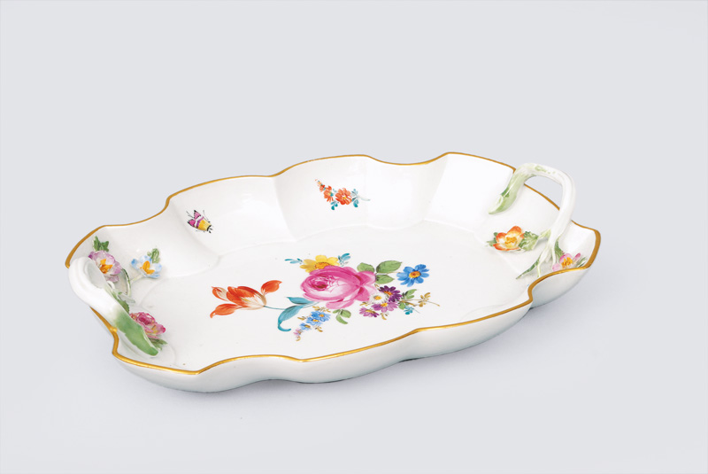 A curved bowl with painted flowers and insects