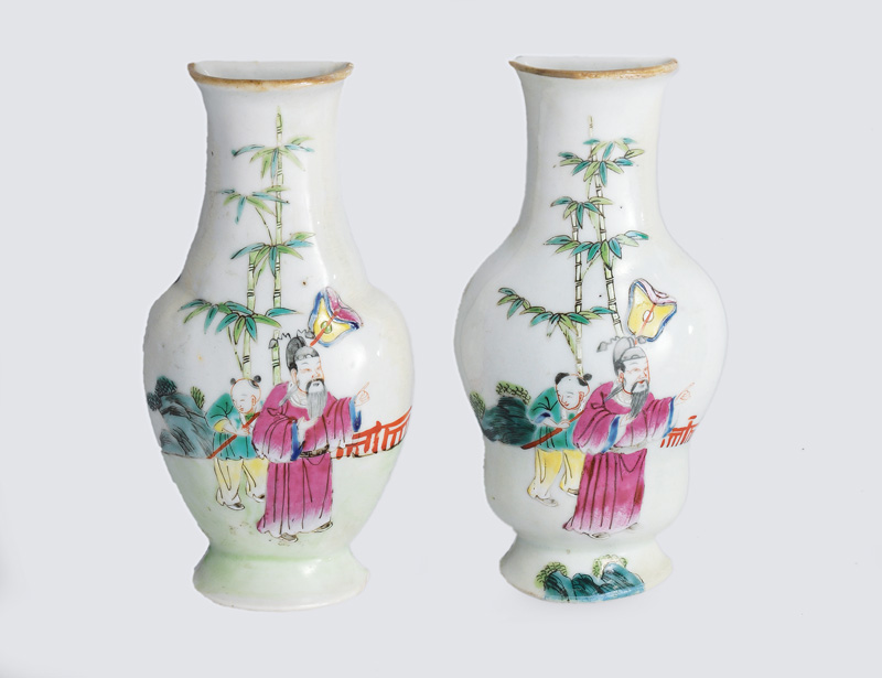 A pair of wall vases with figural garden scene