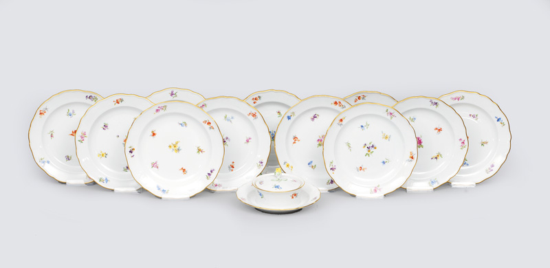 A set of 11 plates and 1 butter dish with scattered flowers and gilded rim