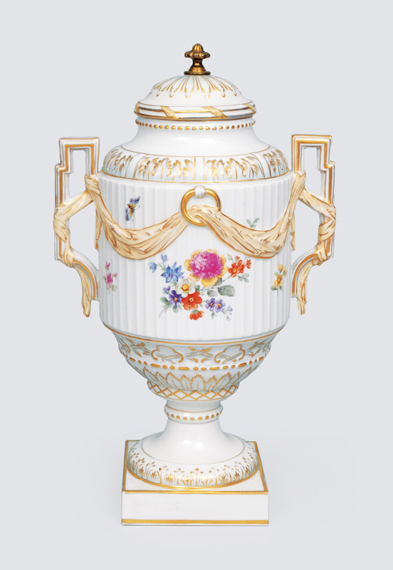 A vase with cover decorated with flowers and insects