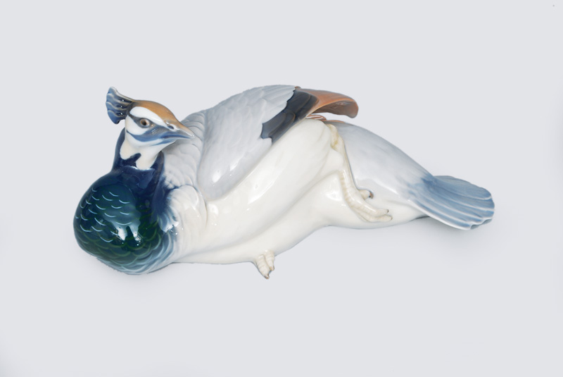 An animal figurine "Lying peacock"
