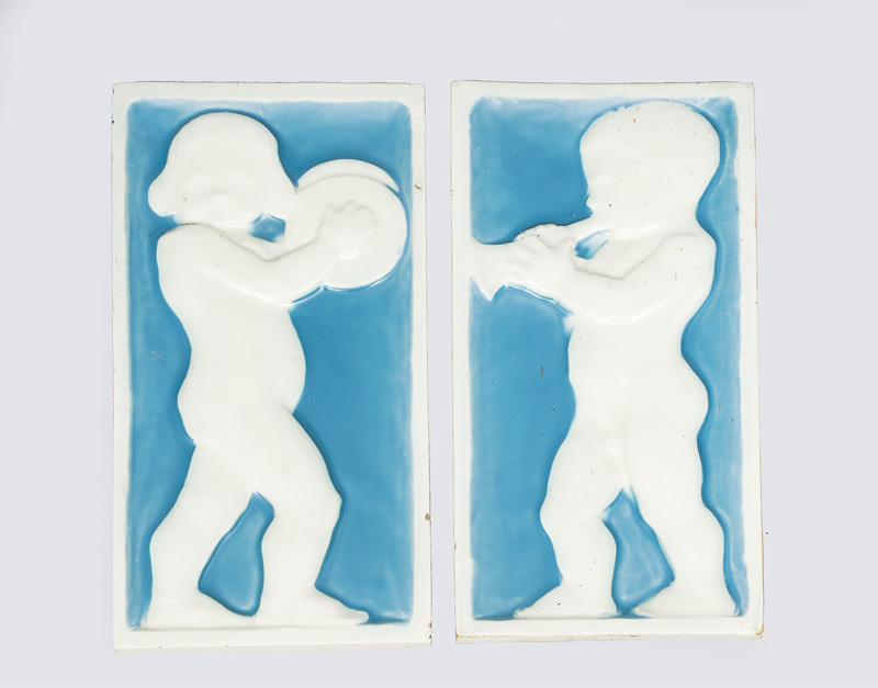 A pair of wall reliefs with children playing music