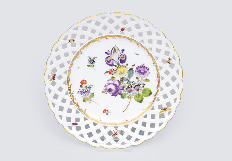 An openwork plate with flowers and insects